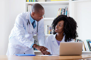 African american mature adult male doctor with nurse