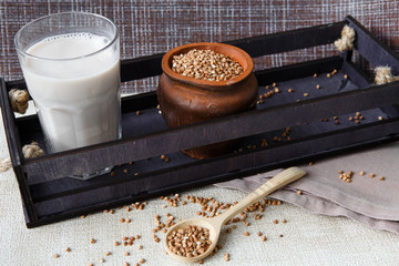 Dry buckwheat groats and vegetable buckwheat milk in a glass Cup. Concept of proper nutrition, vegetarianism, replacement of meat and animal products, healthy lifestyle, diet