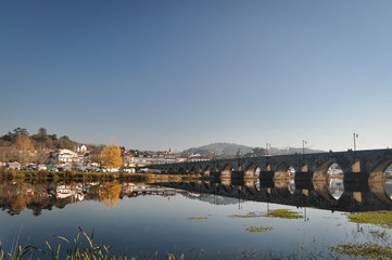 Fototapeta premium City view and stone old bridge across the river . Portugal.
