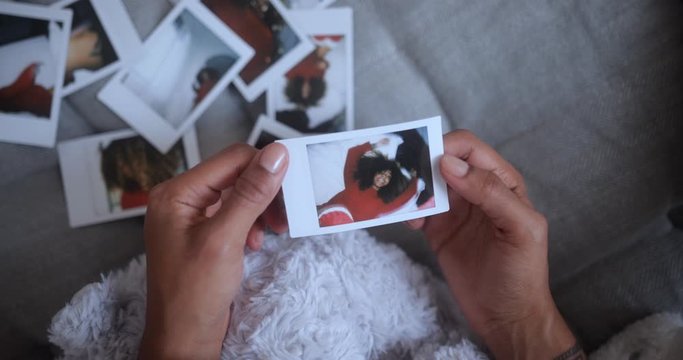Black woman holding photo on the background other Christmas photos