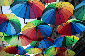 Background colorful rainbow different color umbrellas. unban tourist street decoration.