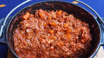 Cooked bolognaise mince in a cast iron pot or dutch oven.