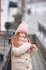 beautiful girl dressed in winter clothes straightens her hair