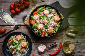 Delicious fresh pasta with meatballs, sauce, cherry tomatoes and basil