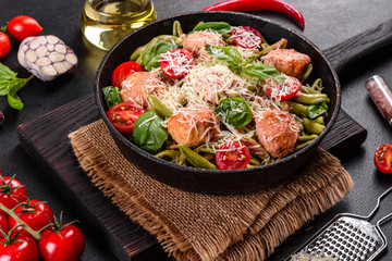 Delicious fresh pasta with meatballs, sauce, cherry tomatoes and basil
