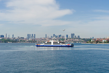 Ferry boat passing Bosphorus. panorama of european part of Istanbul city at background and seagull