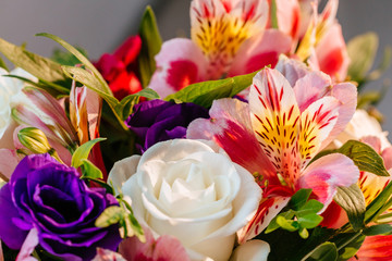 Stylish colorful floral bridal bouquet with roses. Designer fresh flower bouquet from a florist. Beautiful blossoming flower wedding designer bouquet. Close up view