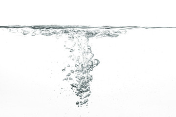 Water poured into tank, bubbles and splashes visible on white background