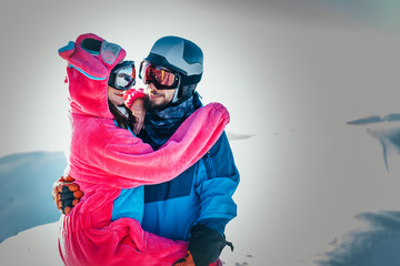 A couple in love kisses in the mountains
