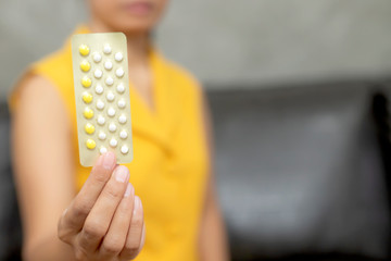 Woman holding combined oral contraceptive pill.Gynecology concept.