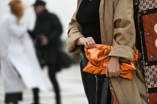Paris, France - February 29, 2020: Neon orange clutch bag - streetstylefw20