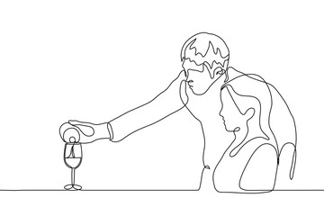 A waiter man pours wine into a glass to a woman visitor to a restaurant. One continuous line drawing of a man treats a woman with wine, leaning over her.