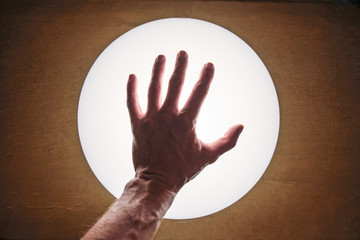 Hand out of contact. Palm silhouette on a white background with a lamp. Scheme template for warning, prohibition.