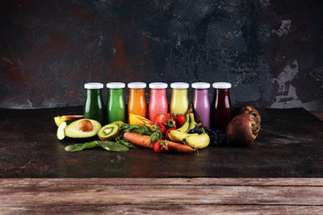Obraz na płótnie Canvas Multicolored smoothies and juices from vegetables, greens, fruits and berries, food background. Detox and dieting, clean eating, healthy lifestyle concept