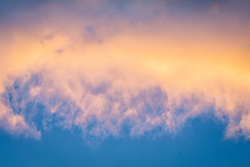 Sky between clouds of a spectacular sunset of multiple colors in autumn day.