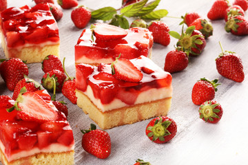 strawberry cake and many fresh strawberries on rustic background table