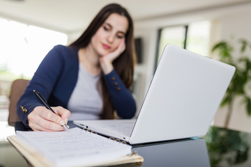 Young woman working from home. Freelancer or online learning concept.