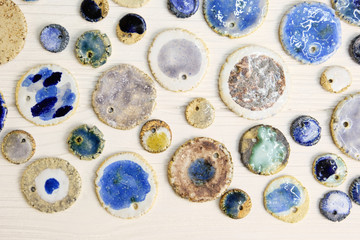 Modern pottery. Decorative ceramic, clay plate. Handmade light pottery.  Set of ceramic, bowls, cup with background.