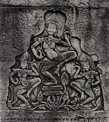 Fototapeta na wymiar Historic Khmer bas-relief with dancing Hindu goddesses
