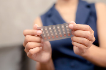 Woman holding combined oral contraceptive pill.Gynecology concept.