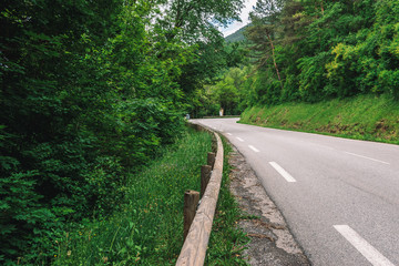 Fototapeta na wymiar A picturesque wide view of an empty road in the valley of Var in the Alps mountains (Puget-Theniers, Alpes-Maritimes, France)