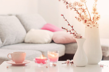 spring pink flowers in vase in white interior