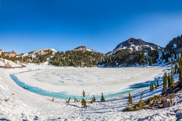 snow on Mount Lassen in the Lassen volcanic national Park with glacier lake