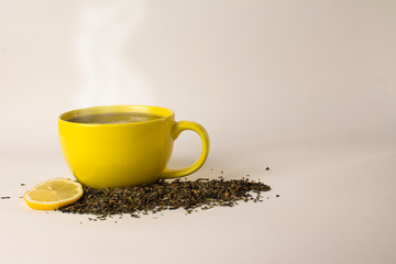 yellow cup with delicious tea and lemon (lime)