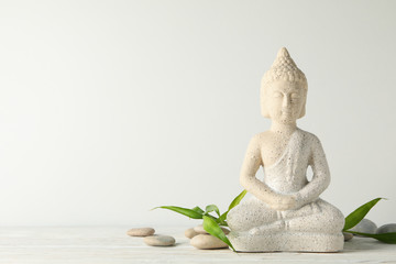 Buddha and stones on wooden table. Zen concept