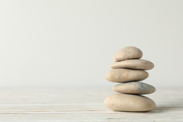 Naklejka na ściany i meble Pile of stones on wooden table. Zen concept