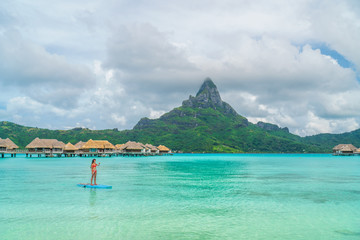 Tahiti beach vacation luxury resort hotel in Bora Bora, French Polynesia. Paddleboarding watersport...