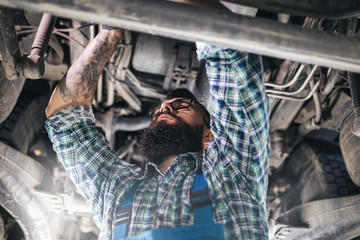 Professional car mechanic working in vehicle repair service.