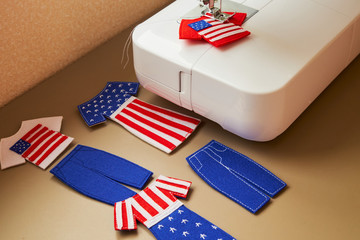 Felt toys clothes in the process of sewing. Gifts with the American flag. National clothes. Presents for Independence Day.
