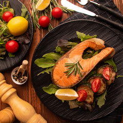 
dinner. fried salmon fish on a beautiful plate in composition