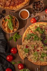 
tasty and juicy pizza and a glass of coca braids with a plate of french fries