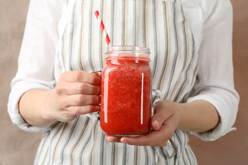 Woman hold glass jar of strawberry cocktail, close up. Summer drink