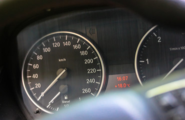 Car dashboard and speedometer and arrow on zero: the automobile is standing.