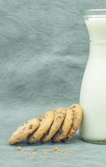 Bottle of milk and oatmeal cookies lying nearby