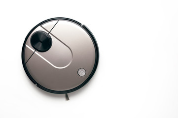 Modern robot vacuum cleaner on white background copy space. New technologies, quick house cleaning,...