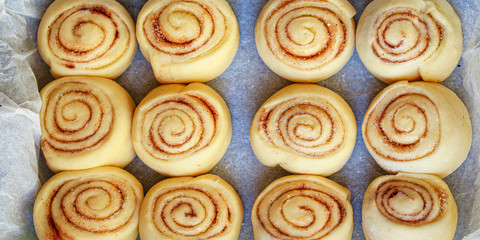 Obraz na płótnie Canvas cinnamon bun roll home baked goods Menu concept healthy food background top view copy space