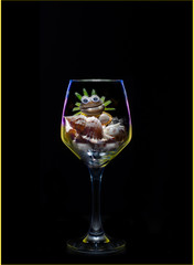 a frog-shaped shell in a glass
