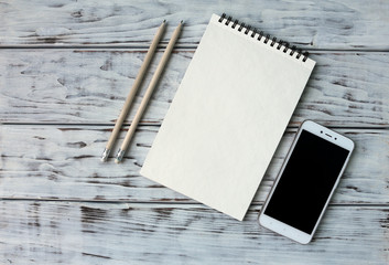 Mobile note and pencil on the board