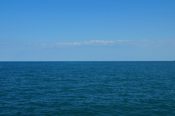 cloudy sky, sea with a smooth horizon