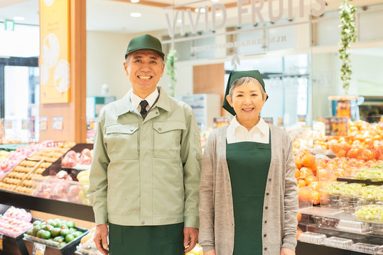 Senior man and woman workers in supermarket