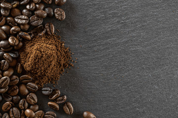 Espresso coffee beans for cup of dark caffeine breakfast on black cafe food or drink background. Morning energy concept and cheerfulness or evening refreshment. Copy space, top view