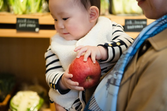 Baby holding apple