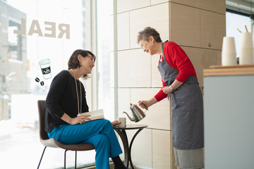 Shop clerk attending regular customer