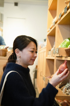 Woman shopping organic vegetable at vegetable store