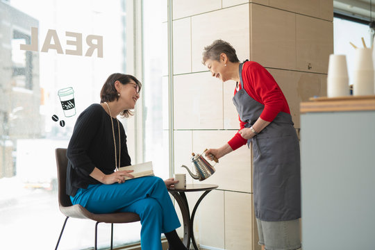 Shop clerk attending regular customer