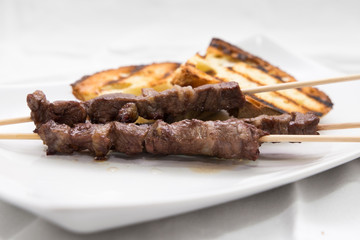 Arrosticini and bruschetta bread: typical Abruzzese dish
